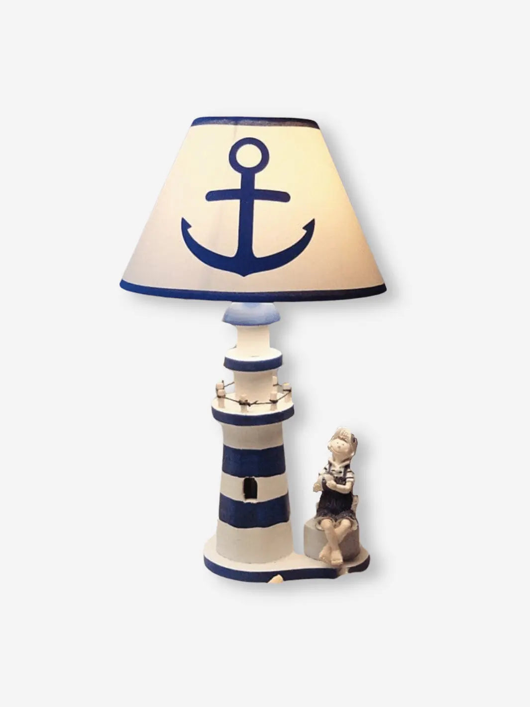 lampe de chevet en bois representant un phare avec une encre sur l abat jour et un petit garcon qui tient un ballon a son pied