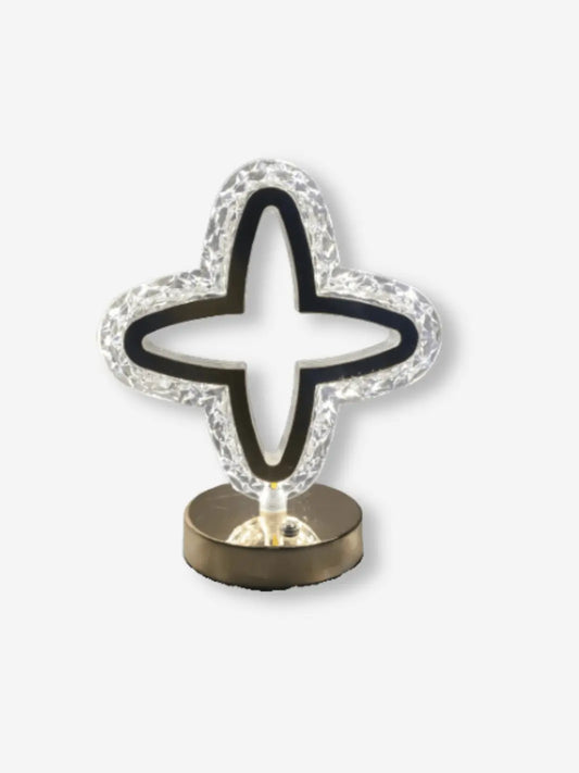 lampe de chevet en cristal en forme d etoile a 4 branches posee sur un socle couleur or