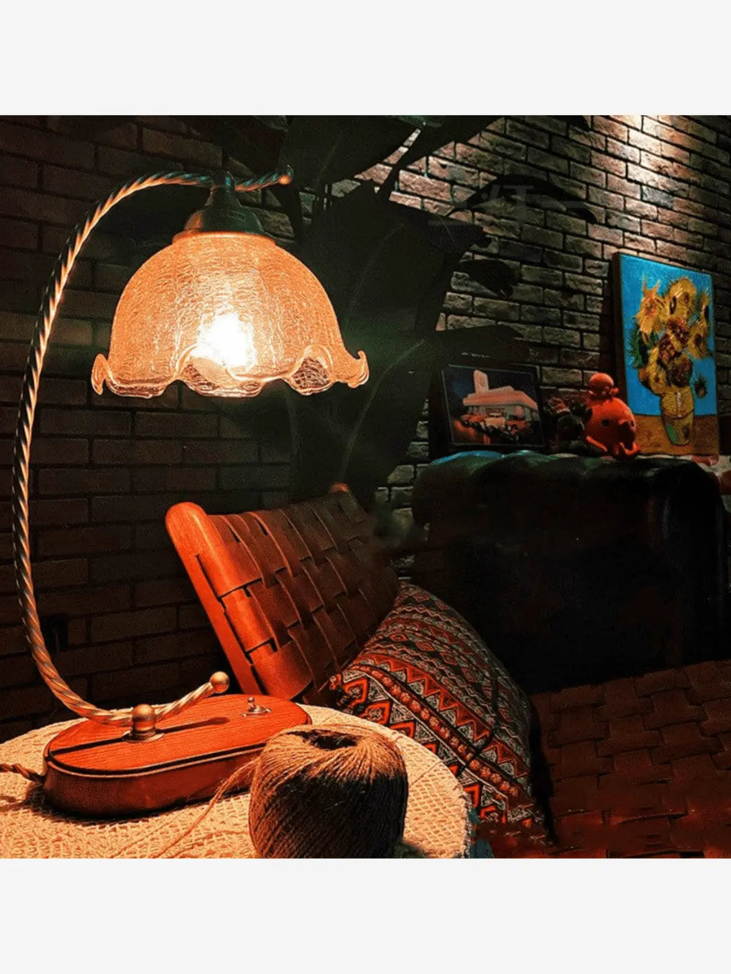 lampe de chevet en bois et metal avec abat jour en verre trasnparent en forme de fleur posee sur une table de nuit